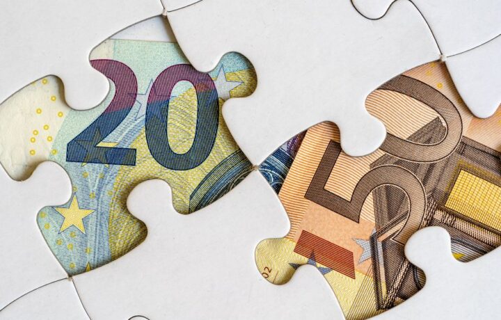 Euro banknotes creatively displayed within a jigsaw puzzle theme.